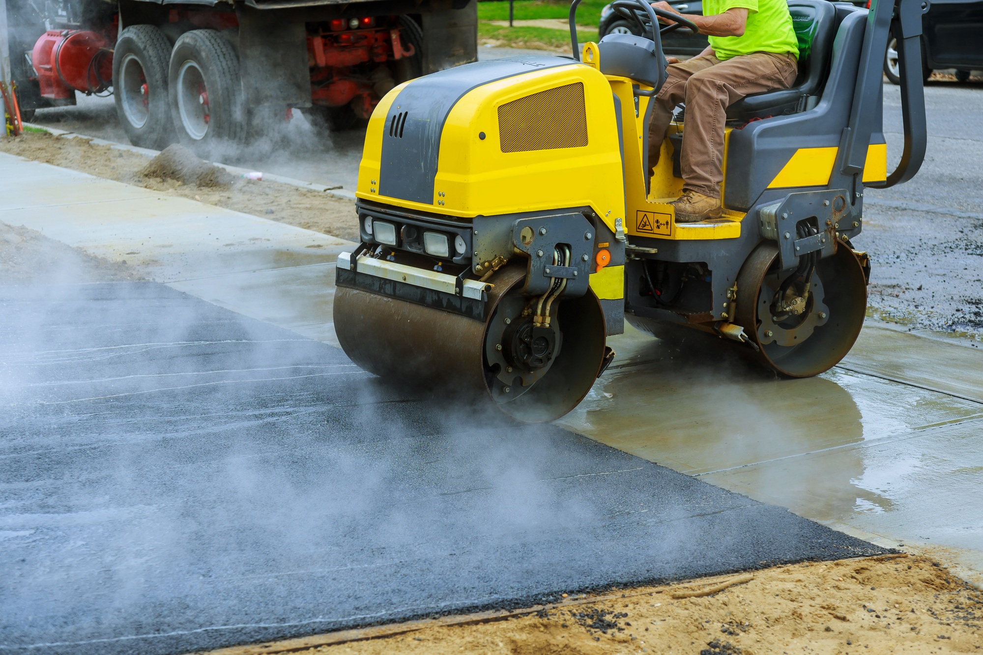 Asphalting construction works with commercial repair equipment road parking for the car with roller